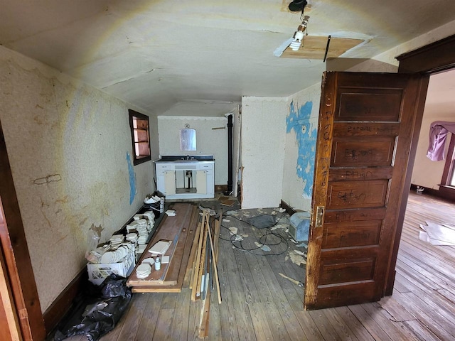 interior space featuring lofted ceiling and hardwood / wood-style flooring