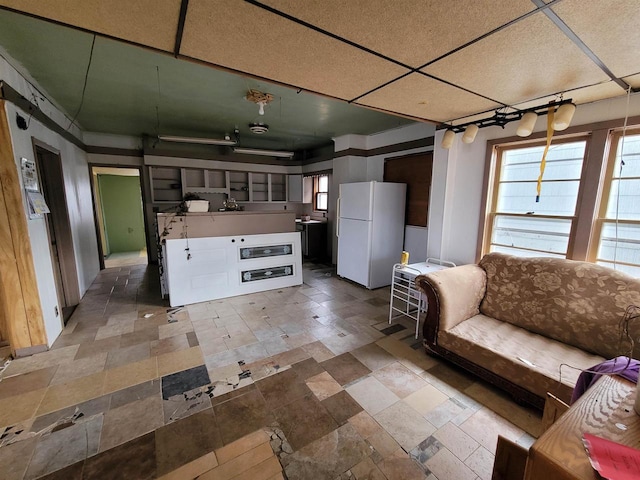 unfurnished living room featuring a paneled ceiling