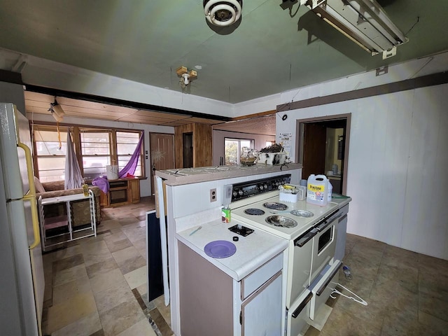 kitchen with white appliances and wooden walls