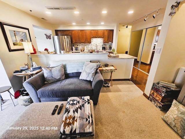 living room featuring track lighting and sink