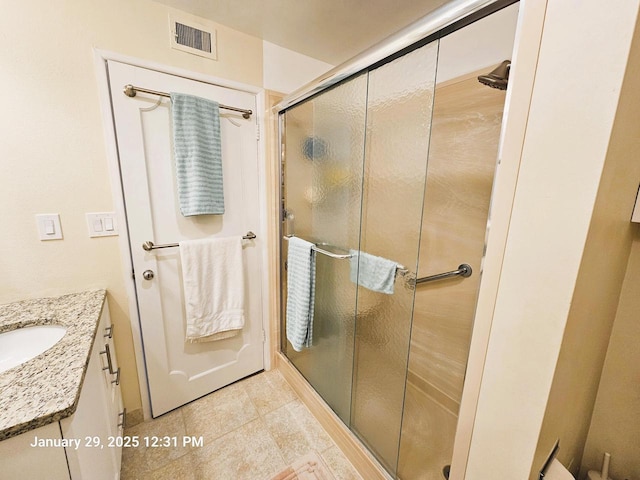 bathroom with vanity and walk in shower