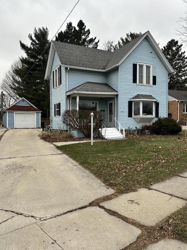 front facade featuring a garage, an outdoor structure, and a front yard