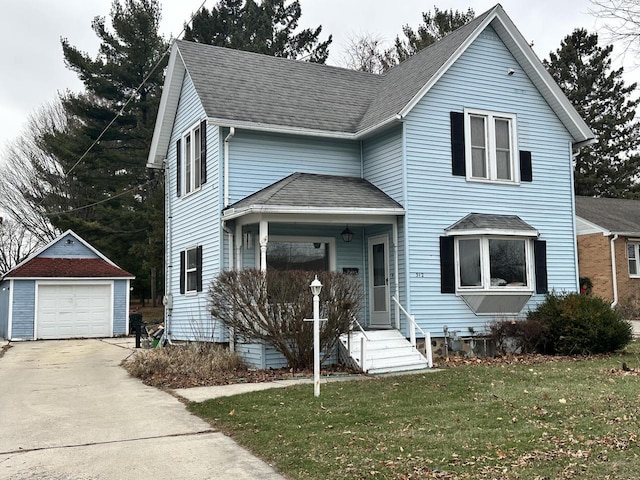 front of property featuring a garage, an outdoor structure, and a front yard