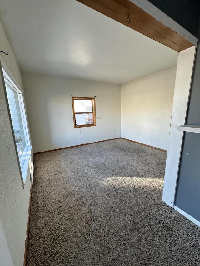 spare room with dark carpet