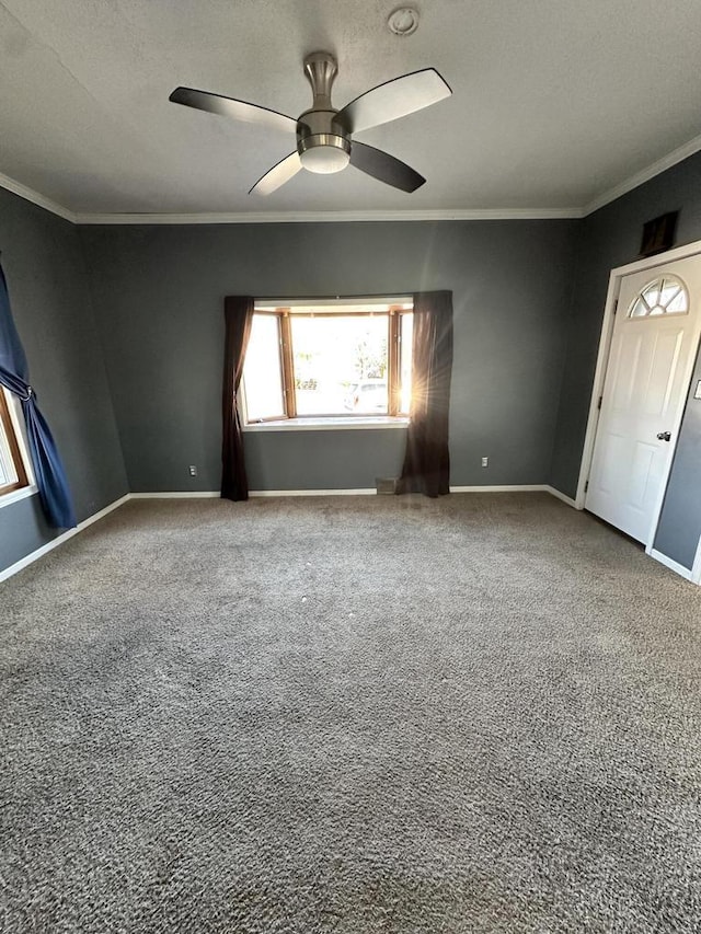 spare room with crown molding and ceiling fan