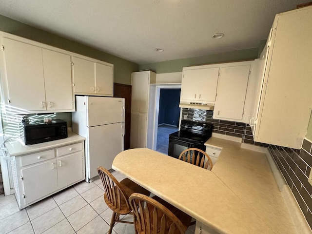 kitchen with white cabinets, light tile patterned floors, decorative backsplash, and black appliances