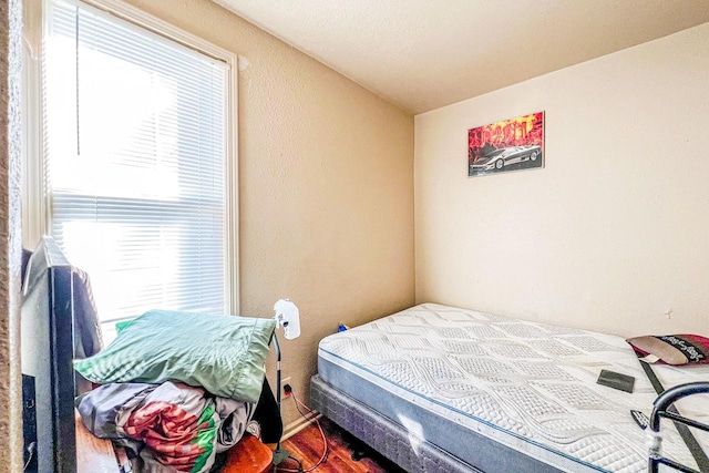 bedroom with hardwood / wood-style floors