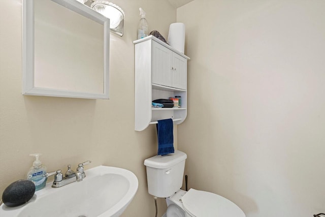 bathroom featuring toilet and sink