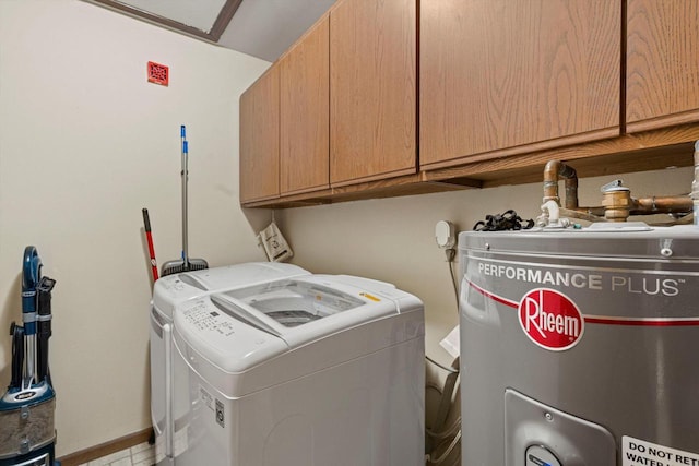 laundry room with water heater, independent washer and dryer, and cabinets