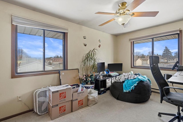 office space with a baseboard heating unit, carpet floors, and ceiling fan