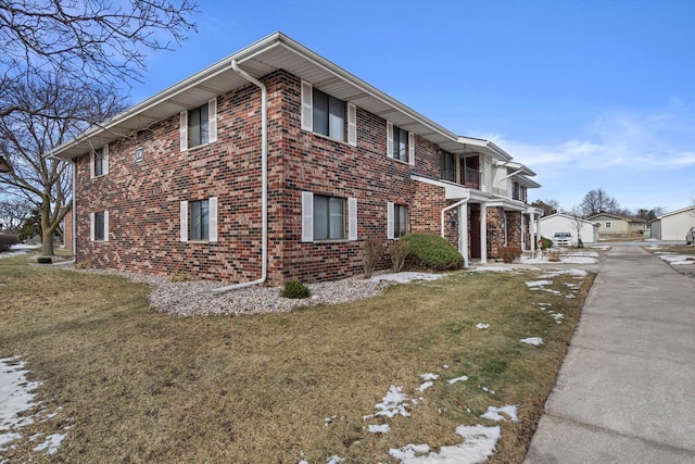 view of side of home with a lawn