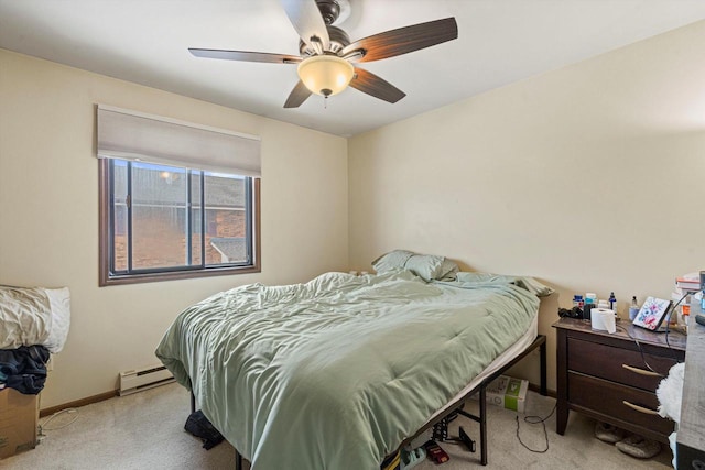 carpeted bedroom featuring baseboard heating and ceiling fan