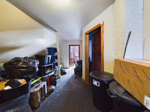 hallway featuring lofted ceiling and dark hardwood / wood-style flooring