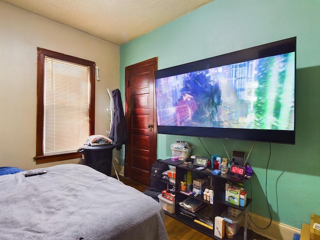 bedroom with hardwood / wood-style floors