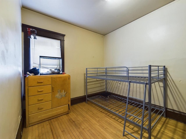 bedroom with hardwood / wood-style flooring