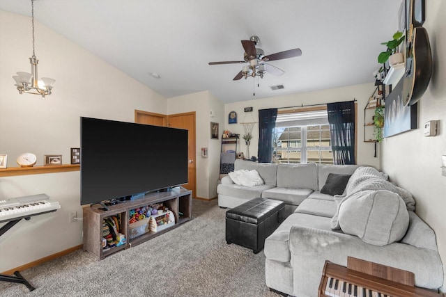 carpeted living room with lofted ceiling and ceiling fan with notable chandelier