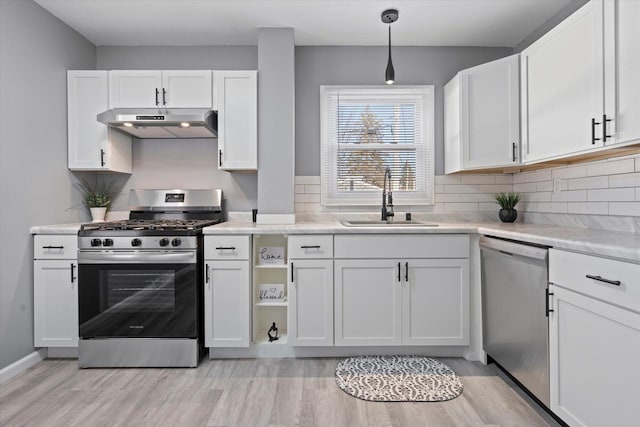 kitchen featuring sink, white cabinets, backsplash, hanging light fixtures, and stainless steel appliances