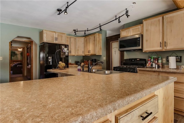 kitchen featuring sink, track lighting, light brown cabinets, and black appliances