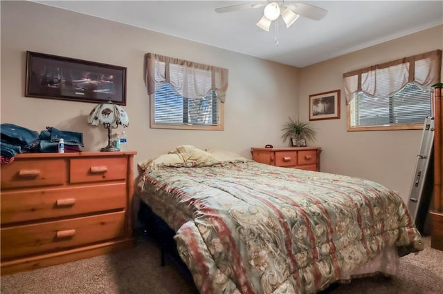 carpeted bedroom featuring multiple windows and ceiling fan