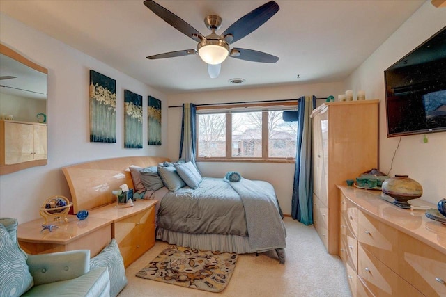 bedroom featuring ceiling fan and light carpet