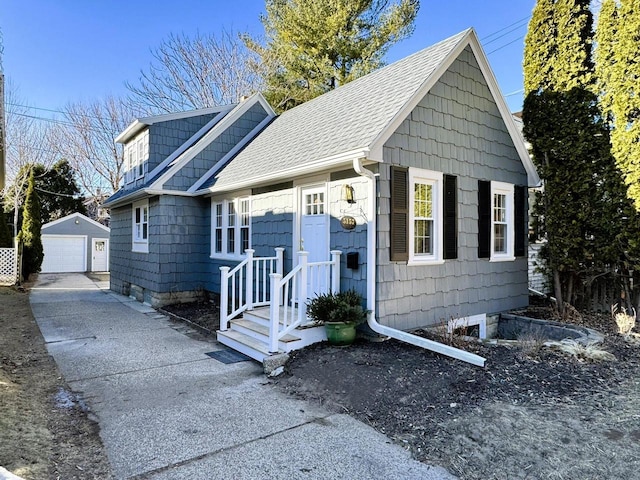 view of front facade featuring a garage and an outdoor structure