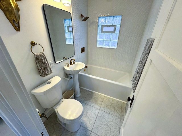 full bathroom featuring sink, washtub / shower combination, and toilet