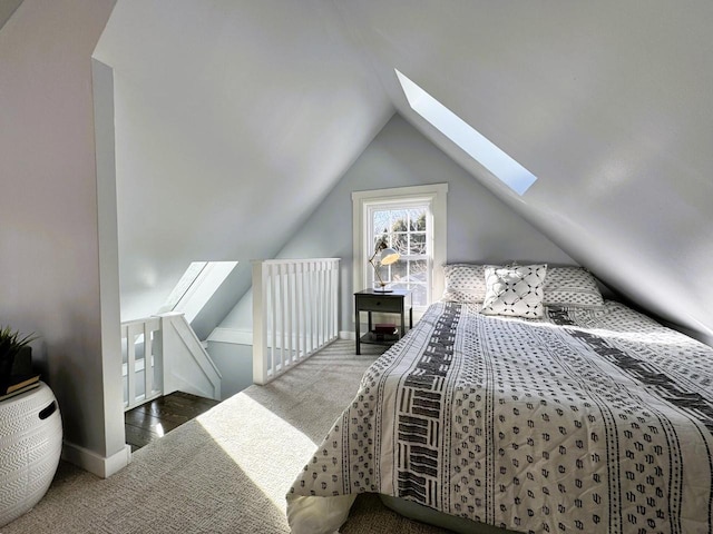 carpeted bedroom with lofted ceiling with skylight