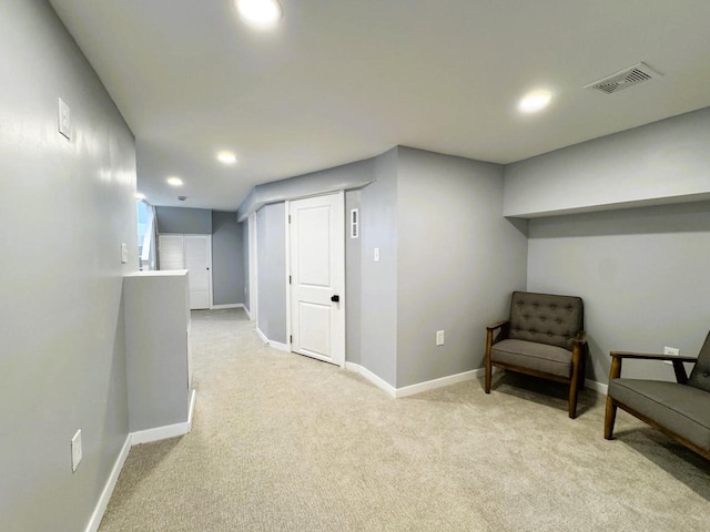 sitting room featuring light carpet