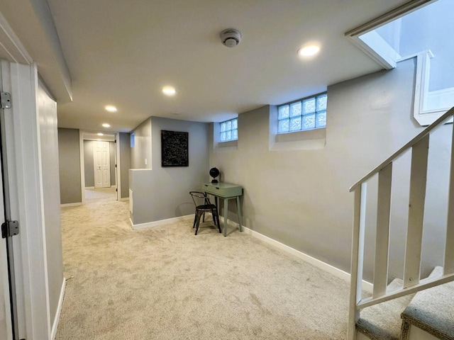 basement featuring light carpet