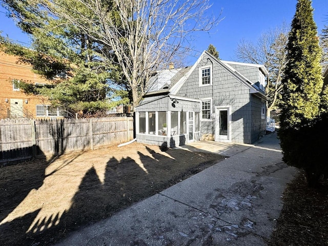 back of property featuring a patio area and a sunroom