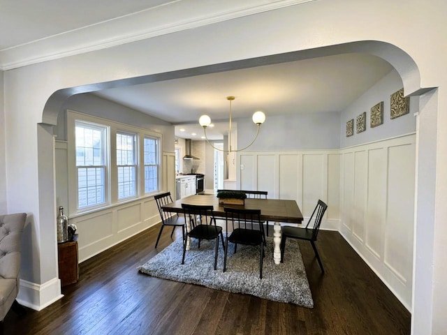 dining room with dark wood-type flooring and an inviting chandelier