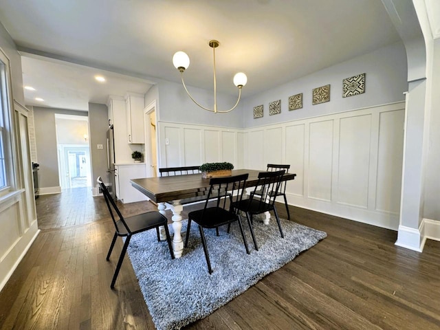 dining space with dark hardwood / wood-style floors