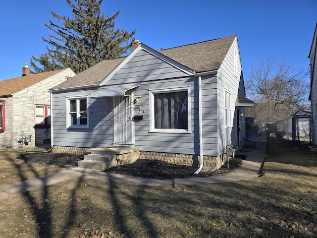 bungalow-style house with a front lawn