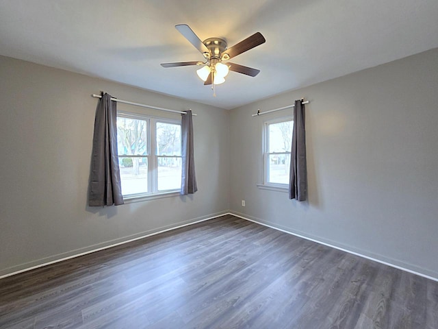 unfurnished room with ceiling fan and dark hardwood / wood-style flooring