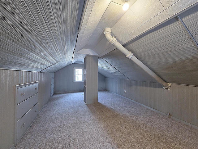 additional living space featuring lofted ceiling and light colored carpet