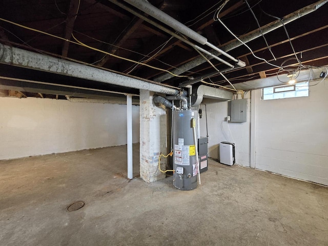 basement featuring electric panel and water heater