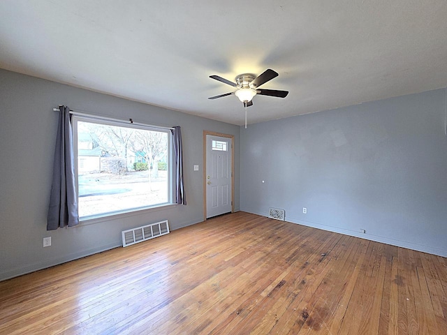 unfurnished room with ceiling fan and light wood-type flooring