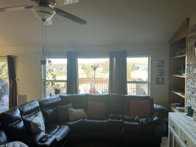 living room featuring vaulted ceiling and ceiling fan