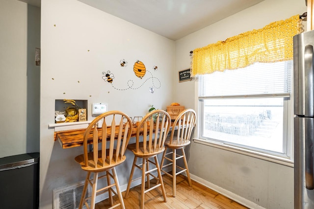 dining space featuring wood-type flooring