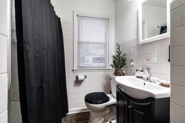 bathroom with vanity, tile walls, curtained shower, and toilet