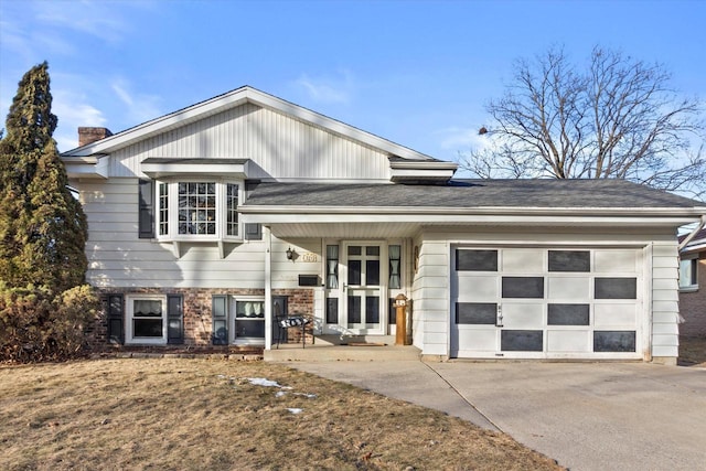 tri-level home with a garage and a porch