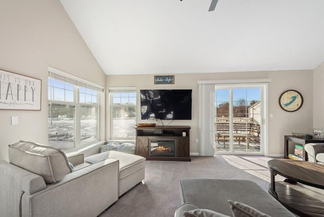 living room featuring carpet floors and high vaulted ceiling