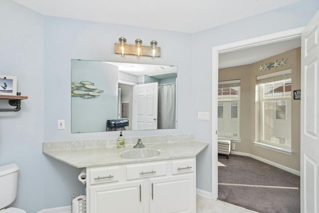 bathroom featuring vanity and toilet