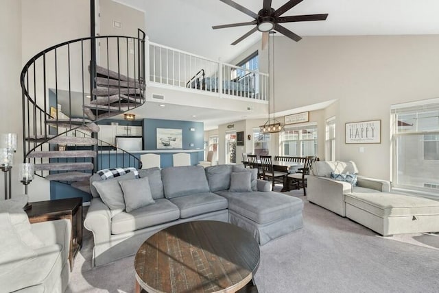 living room featuring ceiling fan, carpet flooring, high vaulted ceiling, and a wealth of natural light