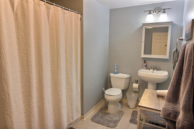 bathroom featuring toilet and tile patterned flooring