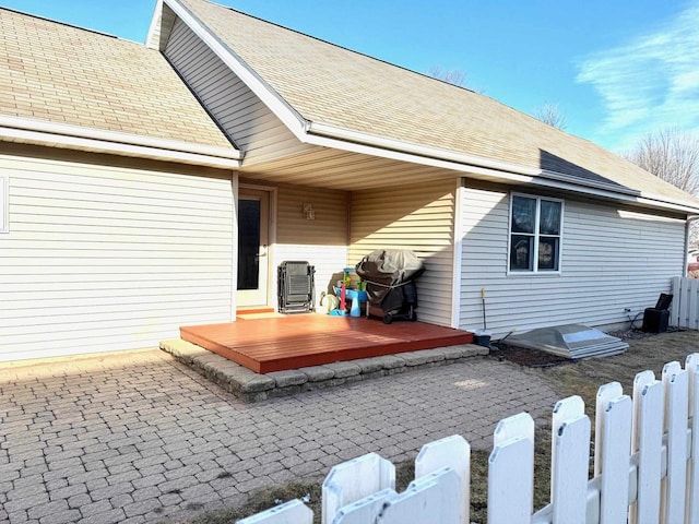 back of property featuring a deck and a patio