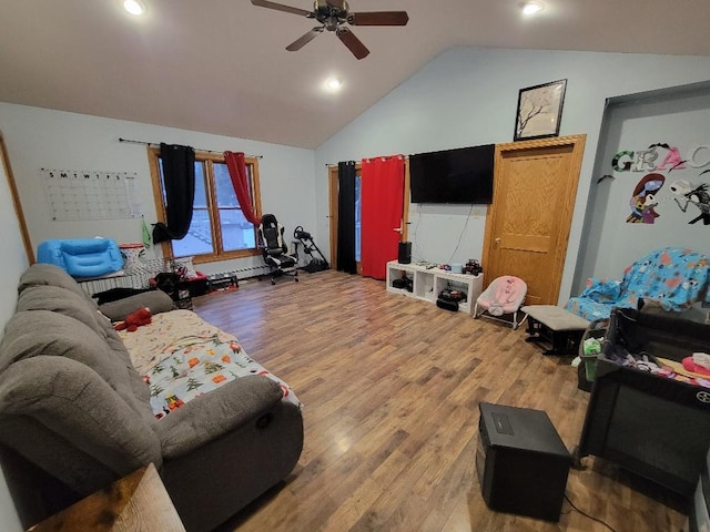 living room with hardwood / wood-style flooring, ceiling fan, and vaulted ceiling