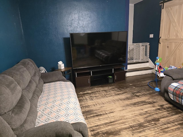 living room featuring wood-type flooring and a barn door