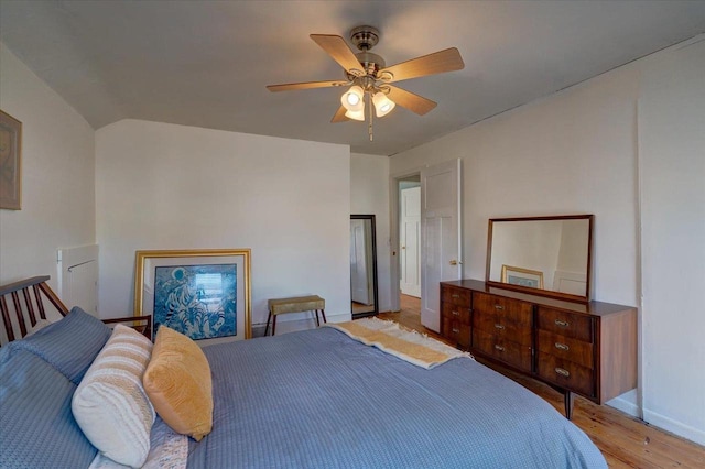 bedroom featuring vaulted ceiling, ceiling fan, and light wood-type flooring