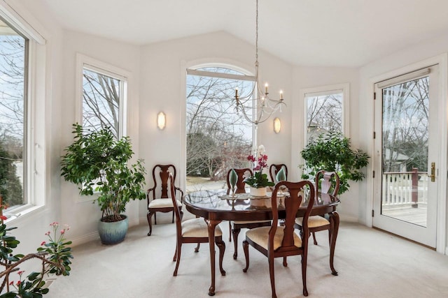 sunroom / solarium featuring vaulted ceiling and a notable chandelier